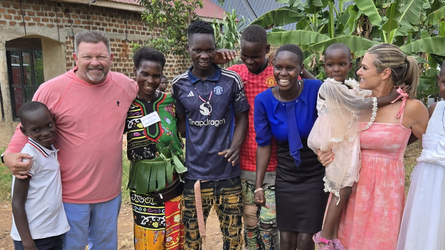 Africa Family Rescue sponsors standing with a family after long-term sponsorship support.